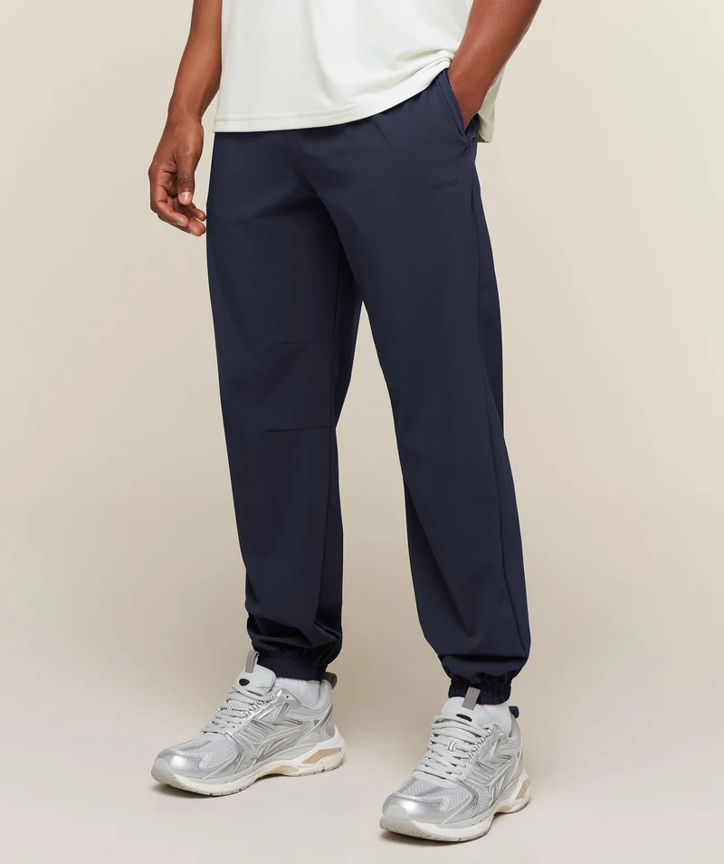 Gymshark Campus Crest Cuffed Woven Pant - Heavy Blue